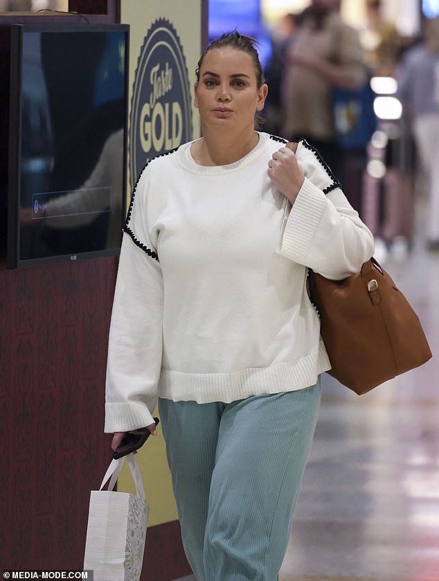 She showed off her dramatic 20kg weight loss in baggy green trousers and a long-sleeved white sweater.