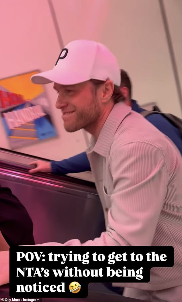 Sharing a hilarious update on his Instagram, Olly shielded his face with a baseball cap as he rode up the escalator and passed posters of himself.