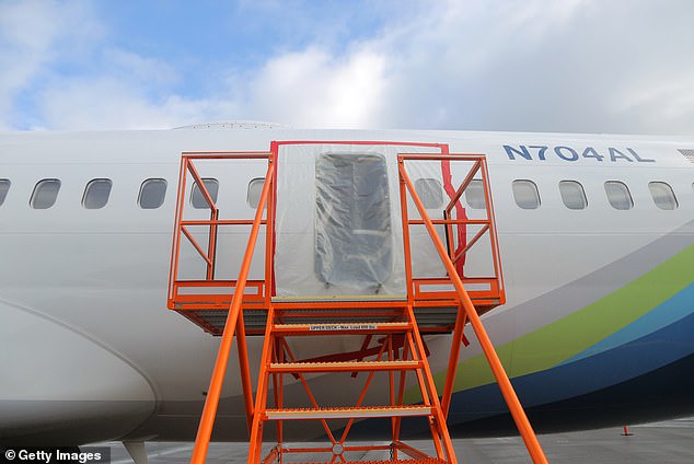 Plastic covers the outside of the Boeing 737 MAX's fuselage plug area after it landed safely