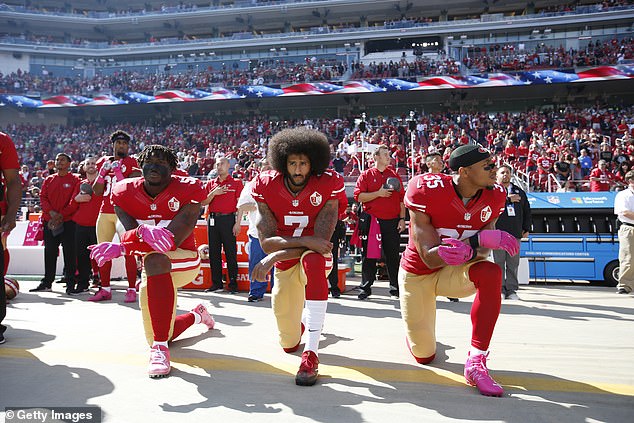 Colin Kaepernick (center) kneels in protest against police brutality in 2016