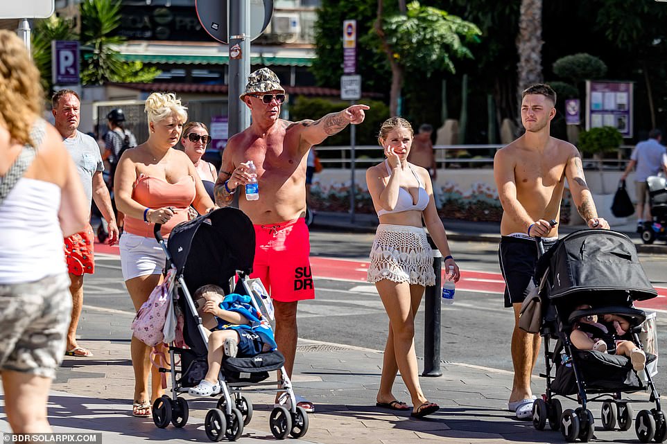 Benidorm is also known for its family-friendly offering. Pictured: People are seen pushing baby strollers in the sunshine on Wednesday