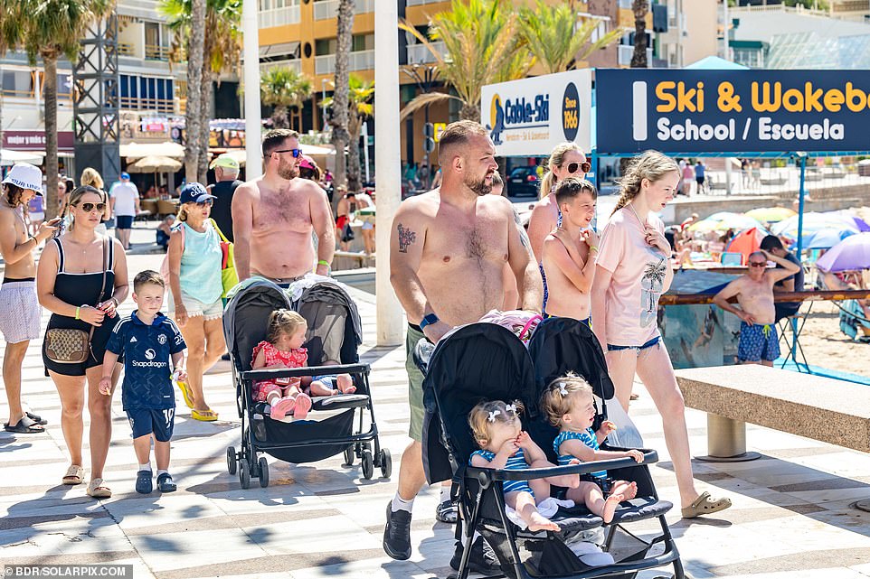 British tourists and expats are seen pushing baby strollers near the beach in Benidorm on Wednesday