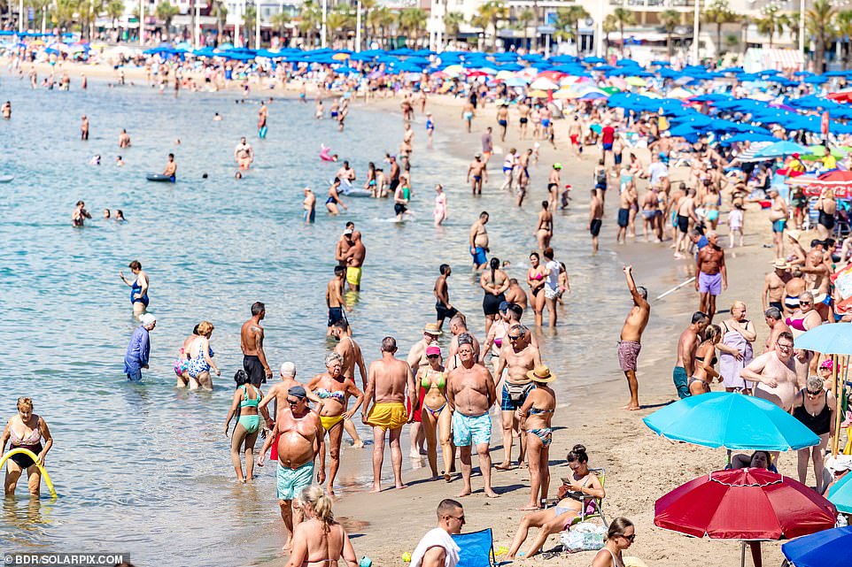 Hundreds of people are seen sunbathing in Benidorm