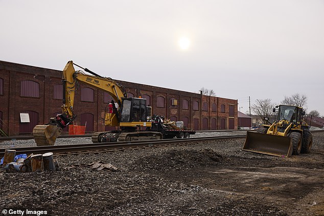 Machinery idles along the train tracks in February 2023 as cleanup efforts continue.