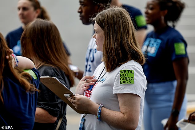 Volunteers receive instructions before Kamala Harris' rally in Charlotte, North Carolina. Many of the attendees wore stickers that read 