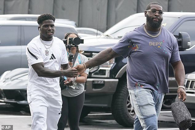 He was flanked by teammate Terron Armstead as he walked through the parking lot in Miami.