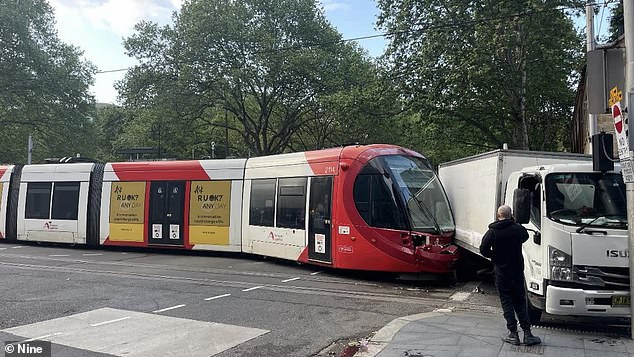 The tram's front windscreen was shattered and the front bumper was also damaged after being crushed by the side of the truck (pictured)