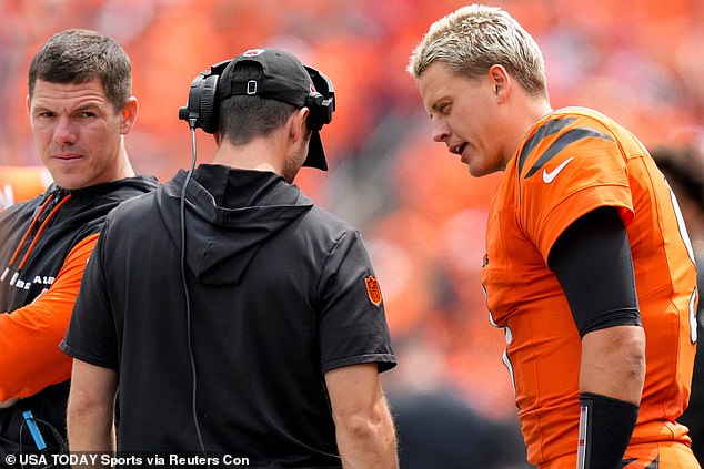 Burrow talks to a coach on the sidelines during Week 1 of the 2024 NFL season on Sunday