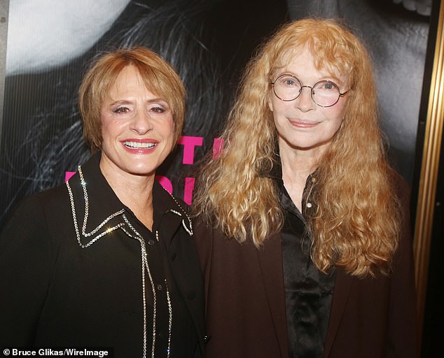 LuPone opted for a long black coat with silver sequin trim along with matching black pants and black heels.