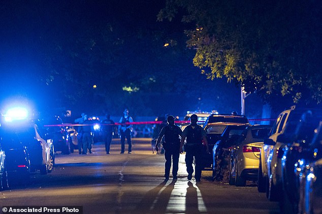 Chicago police work at the scene where two police officers were shot during a traffic stop in the 6300 block of South Bell in the West Englewood neighborhood on August 7, 2021.