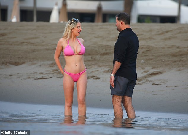 The couple couldn't keep their hands off each other as they enjoyed a dip in the sea on their first holiday together in August.