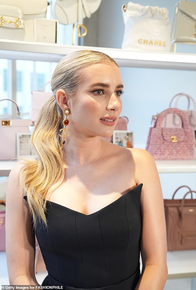 Her pair of asymmetrical Chanel earrings matched her designer handbag from the same brand.