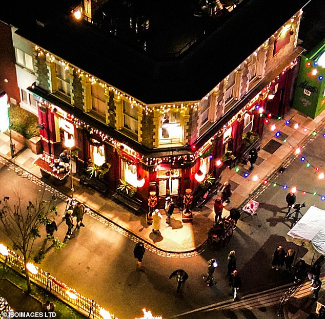 Outside the famous Queen Vic, two large nutcrackers guard the pub's double doors and fairy lights hang delicately around the structure of the building.