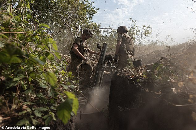 A Ukrainian soldier in a mortar unit prepares to fire a missile