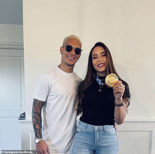 Antony and Rosilene pictured in 2021 with the gold medal they won at the Tokyo Olympics