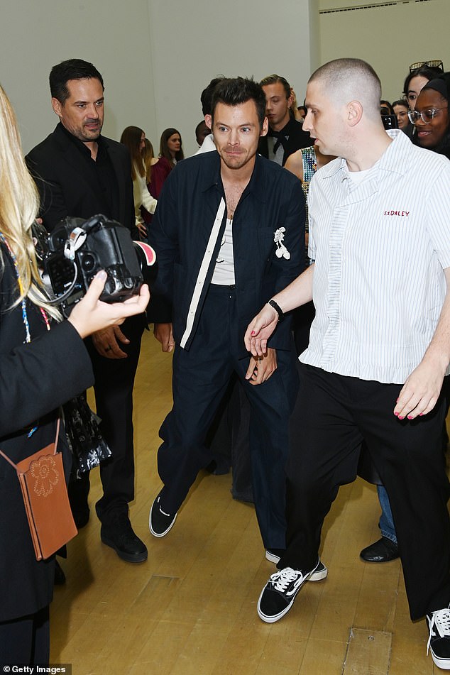 She completed her look with black and white Vans and wore a necklace.