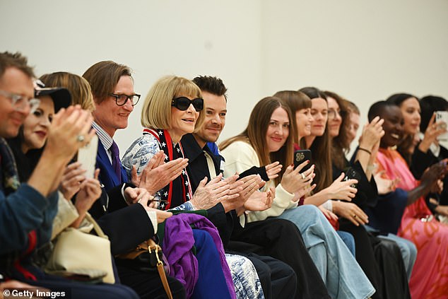 The Golden singer looked in high spirits as he sat front row with Vogue editor-in-chief Anna Wintour, 74, and journalist Hamish Bowles, 61 (fourth and fifth from left).