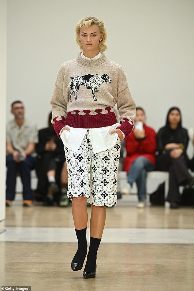 Model Mia Regan, 21, who previously dated Romeo Beckham, showed off her impressive modelling skills as she slayed the catwalk in a beige jumper that featured an embroidered dog in the centre.