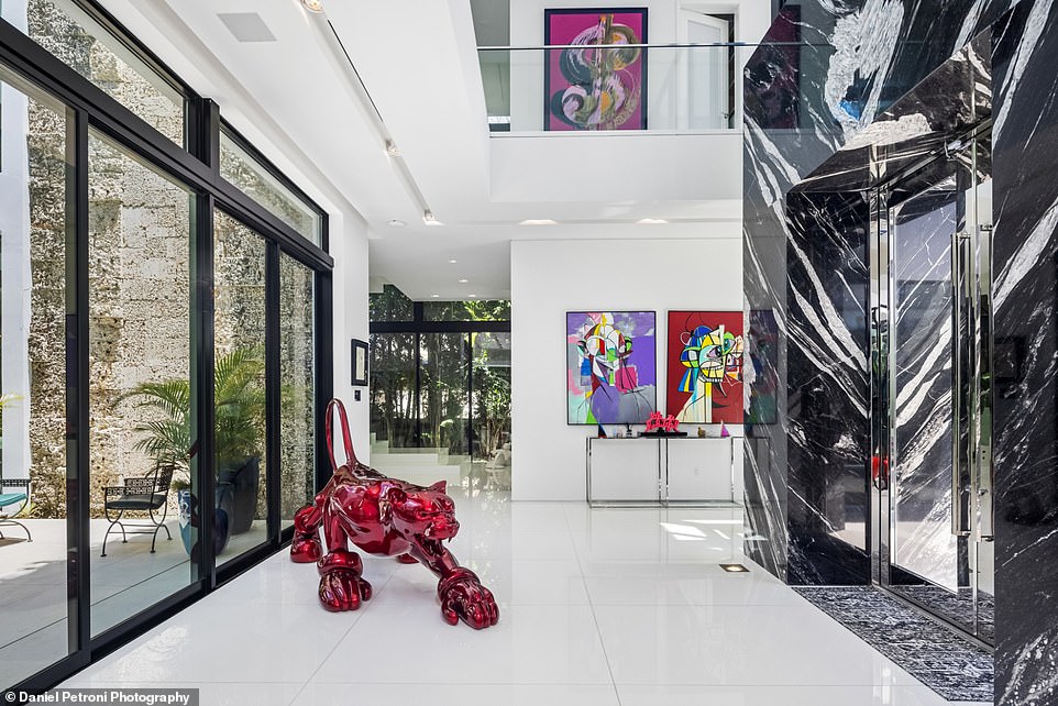 Natural light fills the spacious home that features unique statues and modern art.