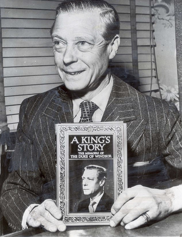 Former King Edward VIII, now Duke of Windsor, holds a copy of his 1951 memoirs, A King's Story