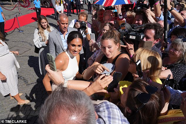 He is an ever-present force at the Sussexes' engagements, seen here standing behind Meghan in 2022 at an Invictus Games launch event in Dusseldorf, Germany.