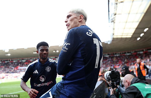 Garnacho celebrated his goal sitting on the advertising board and crossing his arms