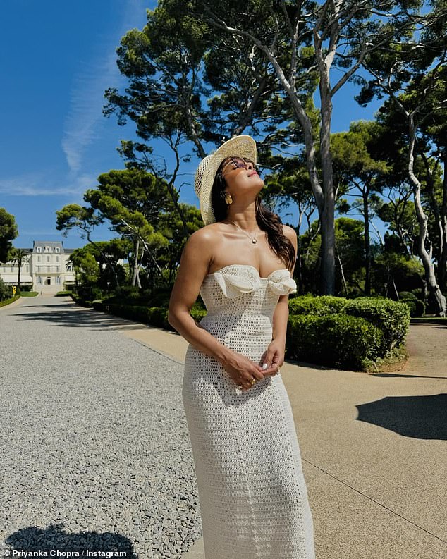 In a final snap once they got off the boat, Priyanka soaked up the sun in a long knit dress that matched her hat.