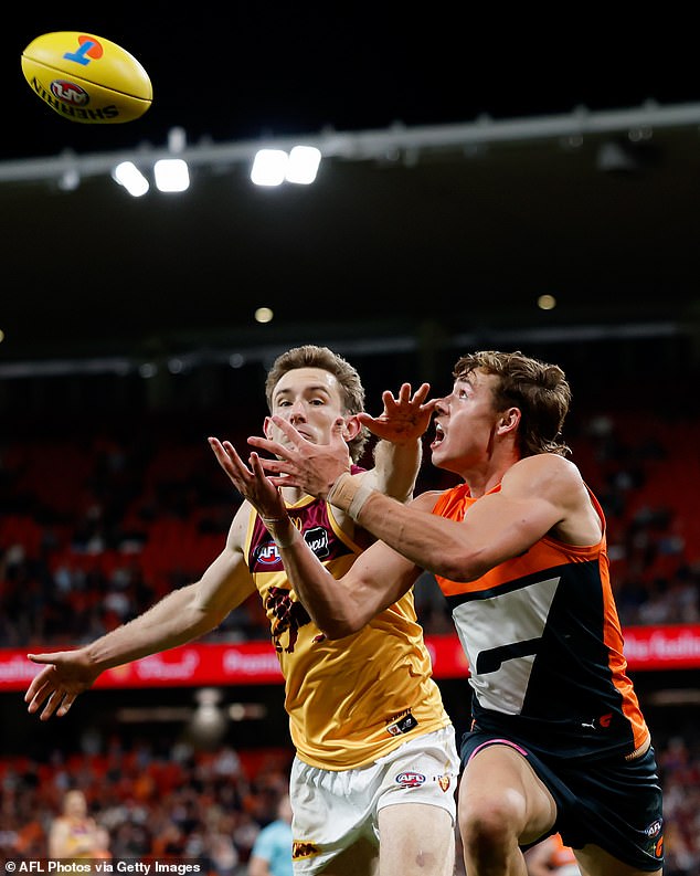 Giants' Aaron Cadman and Lions' Harris Andrews compete for the ball during the 2024 AFL First Semi-Final match between the GWS GIANTS and Brisbane Lions at ENGIE Stadium.