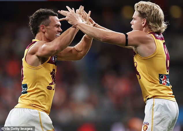 Cam Rayner (left) and Will Ashcroft (right) of the Lions celebrate the victory at the end of the match