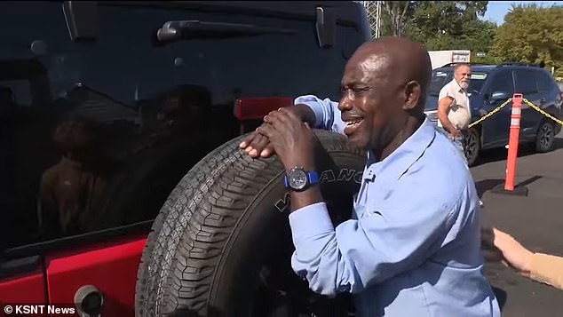 He is seen wrapping his arms around the giant tire as one of the kids pats him on the back.