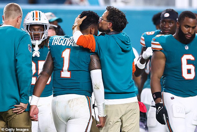 As the quarterback left the field, his coach Mike McDaniel gave him a kiss on the head.