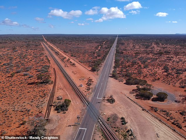 No serious injuries were reported among the train passengers (pictured is one of the crossings of The Ghan with the Stuart Highway)