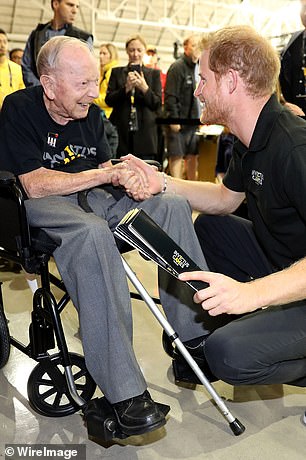 Prince Harry shakes hands with Norm Baker, a 102-year-old World War II veteran, at the Invictus Games in Toronto in 2017