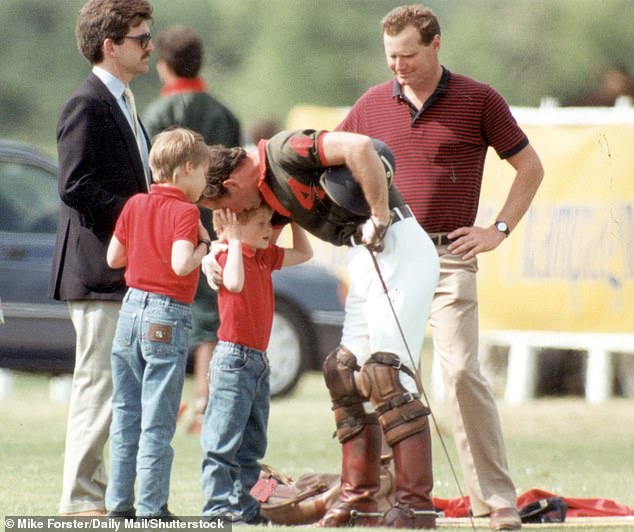 Prince Charles appears to speak sternly into his son's ear at a polo match in Cirencester, 1990