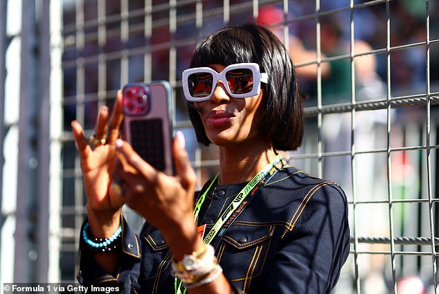 The brunette beauty was in high spirits throughout the day as she waved to the crowd and continued to fight for her own photos.