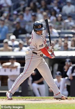 Rafael Devers #11 of the Boston Red Sox is hit by a pitch in the first inning