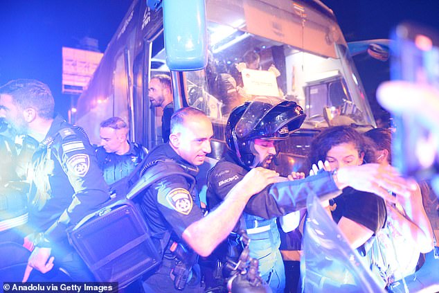 Israeli forces intervene as thousands of Israelis gather with banners and Israeli flags to protest against Israeli Prime Minister Benjamin Netanyahu and his government for not signing the ceasefire agreement with Gaza and to demand a hostage exchange deal with the Palestinians in Tel Aviv, Israel, September 14, 2024