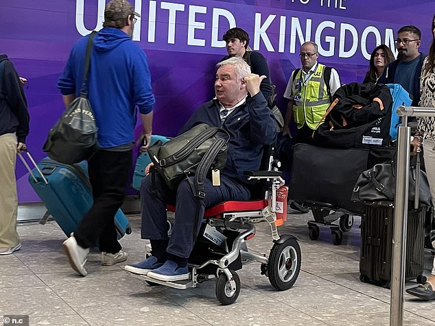 The Northern Irish presenter took the opportunity to check his phone after landing and was seen still wearing his wedding ring.