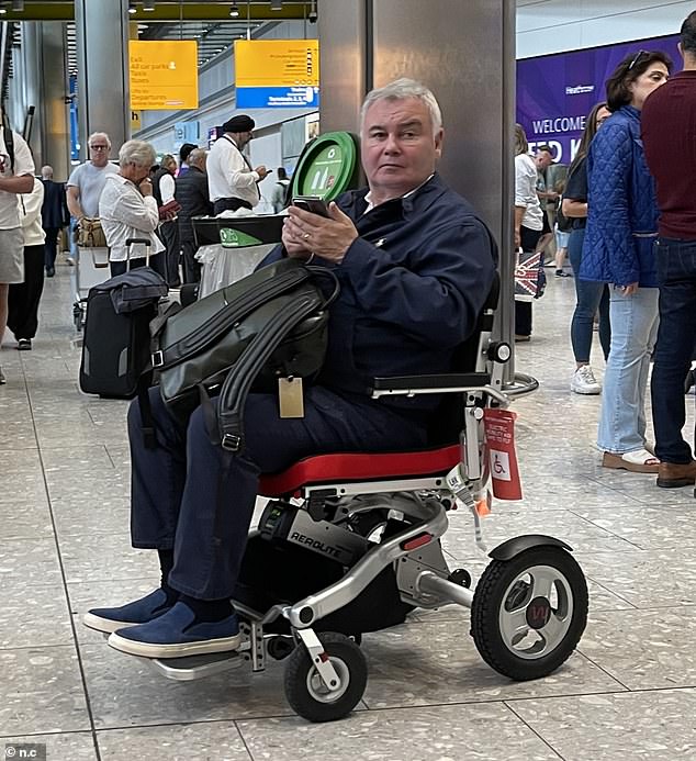 He cut a casual figure in a navy jacket and jeans, with matching slip-on shoes and carrying his backpack on his lap.