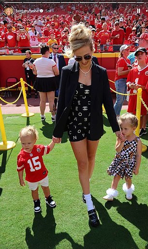 Brittany Mahomes poses during Sunday's game with her and Patrick's children