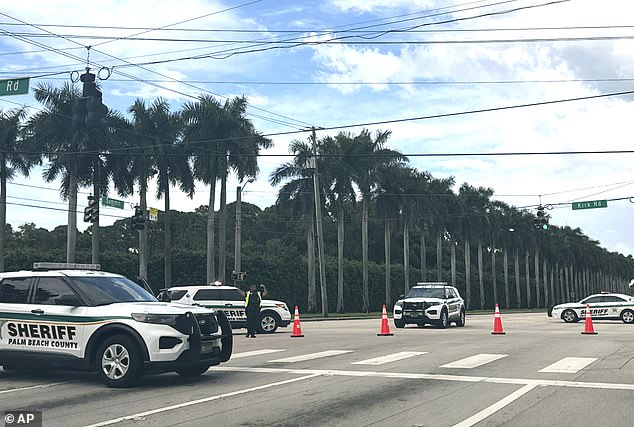 Palm Beach Sheriff's Department vehicles were stationed outside Trump International Golf Club on Sunday after gunshots were reported in the vicinity of where the former president was playing golf.