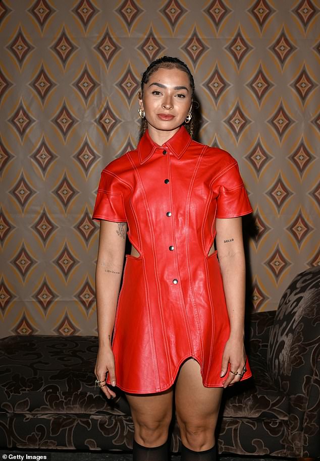 The 30-year-old songwriter showed off her long legs in a fitted, short-sleeved leather dress that featured buttons and cut-out detailing on the sides.