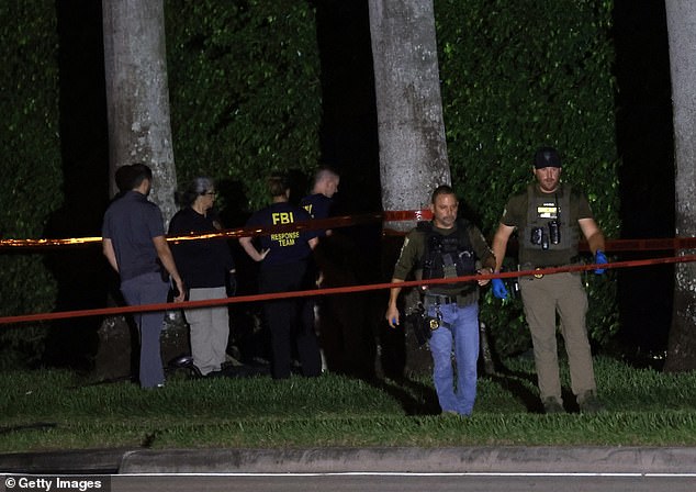 The dire threat to the former president was first noticed by a Secret Service agent who noticed something out of the ordinary protruding from the wire fence surrounding the golf course. (pictured: police personnel investigating the scene on Sunday night)