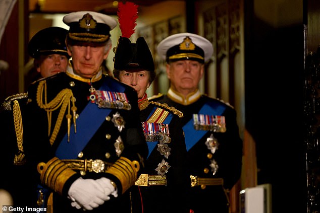 Charles wears a Navy admiral's uniform while his brothers follow him, also in military uniform.