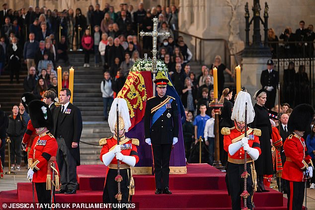 Prince William stands at one end of the coffin while the other grandchildren stand on either side and Harry stands at the other end.