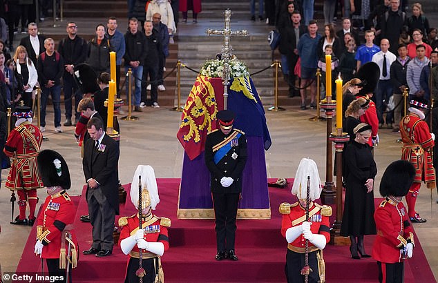 Standing with their heads bowed, the eight grandchildren maintained a 15-minute vigil.