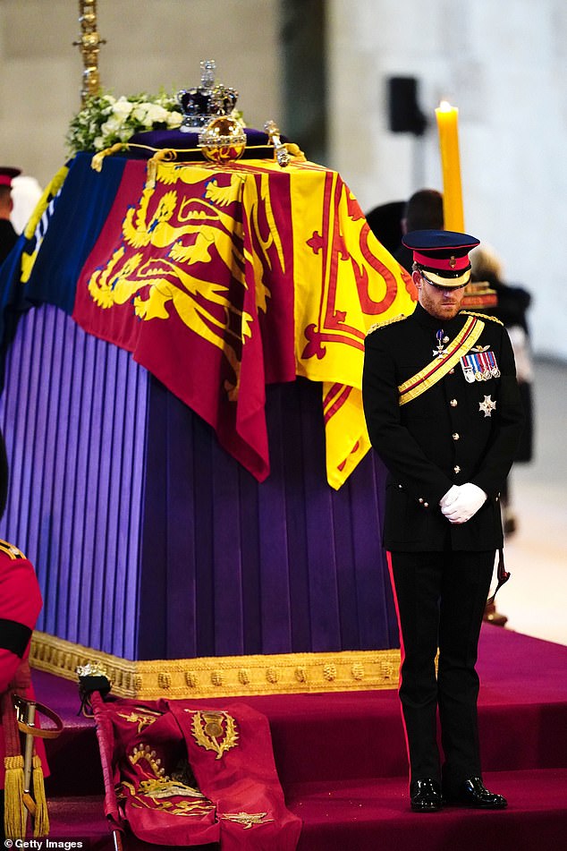 Prince Harry stands at the end of his late grandmother's coffin.