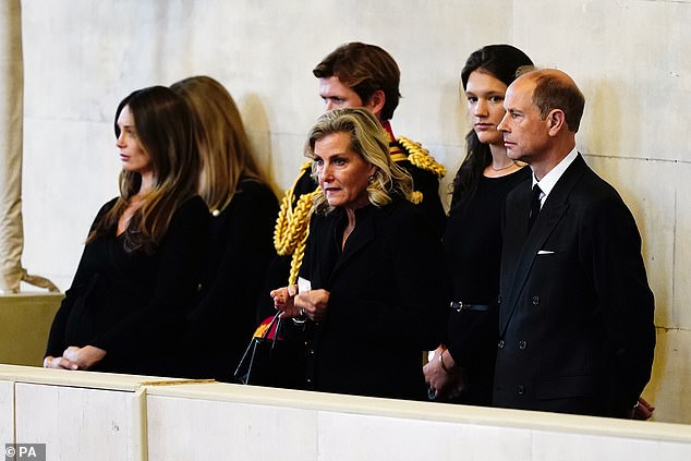 The then Earl and Countess of Wessex look on as their grandchildren hold a vigil.