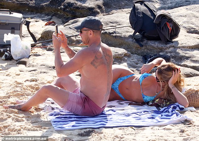 Meanwhile, her heavily tattooed boyfriend flaunted his muscular, tattooed physique in pink shorts.