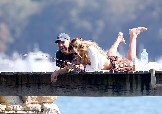 The couple laughed as they did some fishing off the dock.